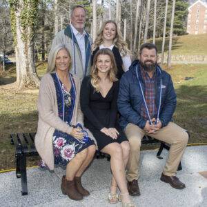 A heritage student and four family members pose.