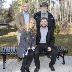 A heritage student and three family members pose.